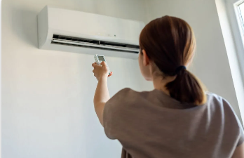 A woman pointing a remote control