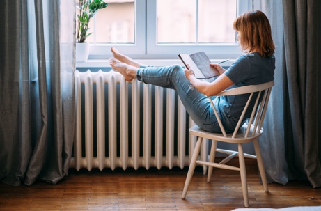 A woman relaxes with her feet up
