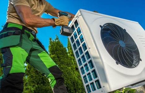 technician installs an air conditioning unit