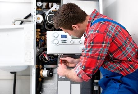 A repairman in blue overalls