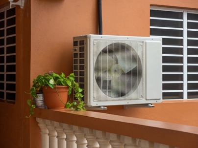 Mounted on a wall is an air conditioning unit